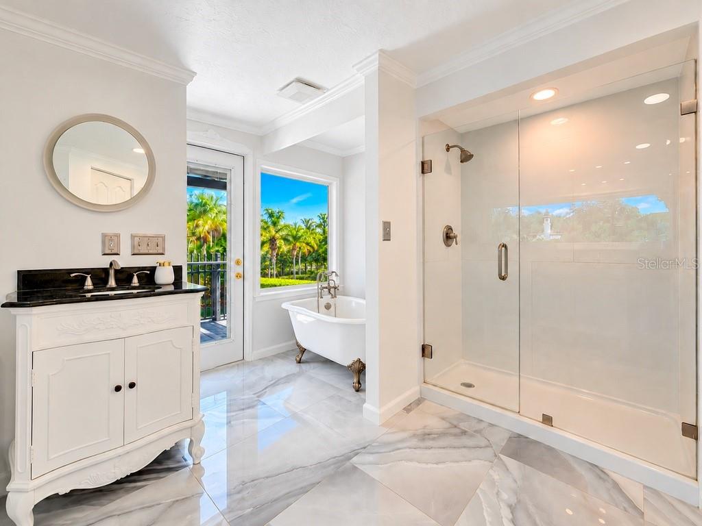 VIRTUALLY RENOVATED  Imagine the possibilities! Conceptual renovation of the upstairs primary bath featuring a freestanding tub, picture window and refreshed finishes. Improvements shown are not currently existing.