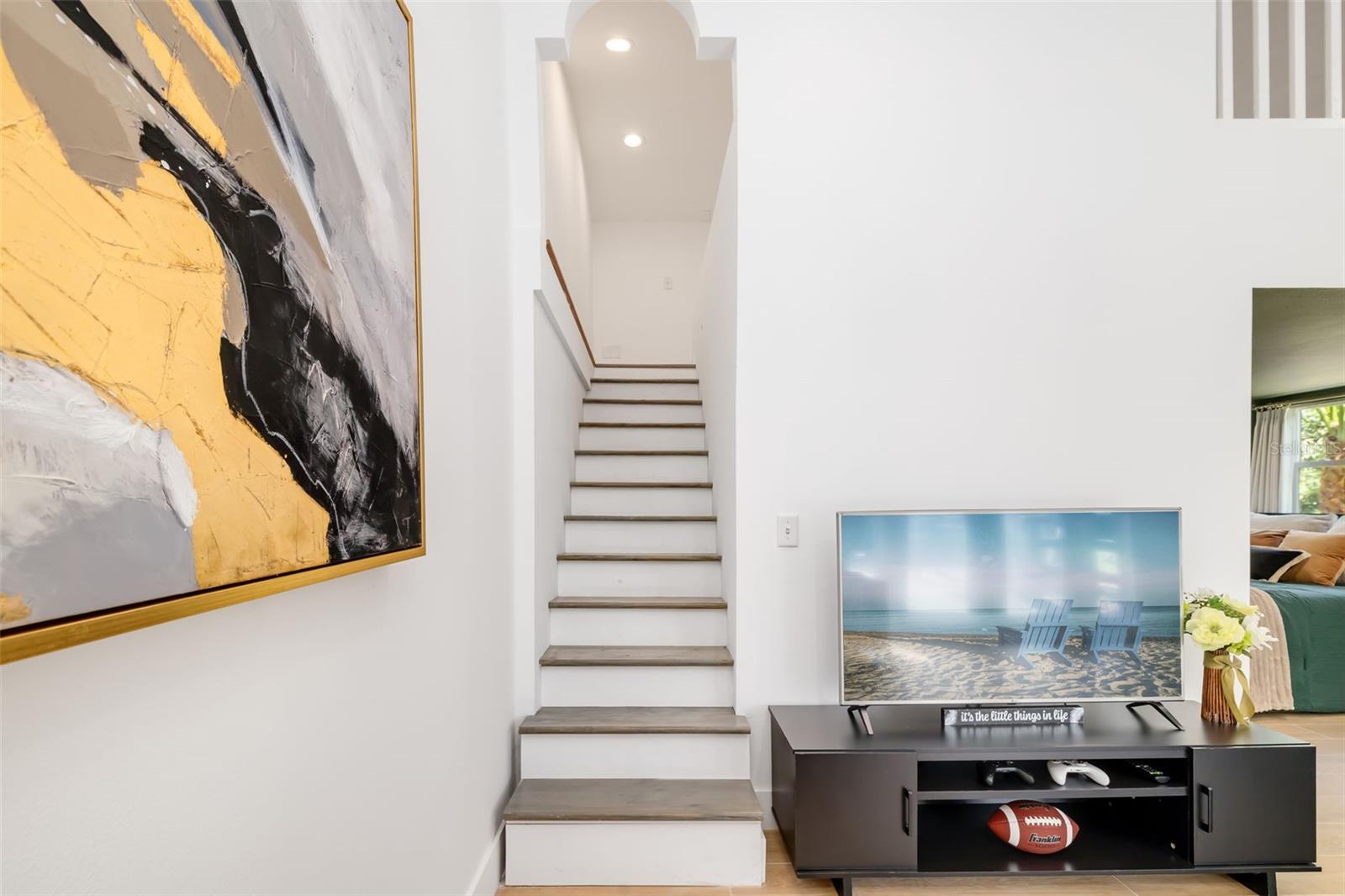 Additional living area and staircase leading to the loft/flex spacepart of a highly adaptable portion of the home ideal for guests, extended family or multigenerational living.