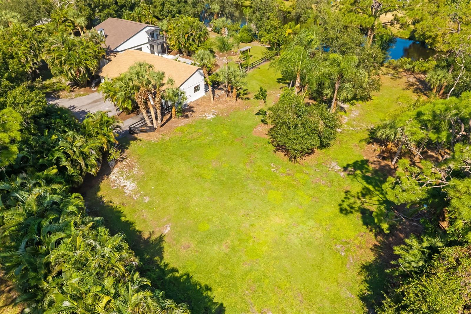 Aerial view highlighting the generous open area of this two-acre propertyan exceptional opportunity to explore additional garage, workshop, recreational or equestrian uses, subject to applicable approvals.