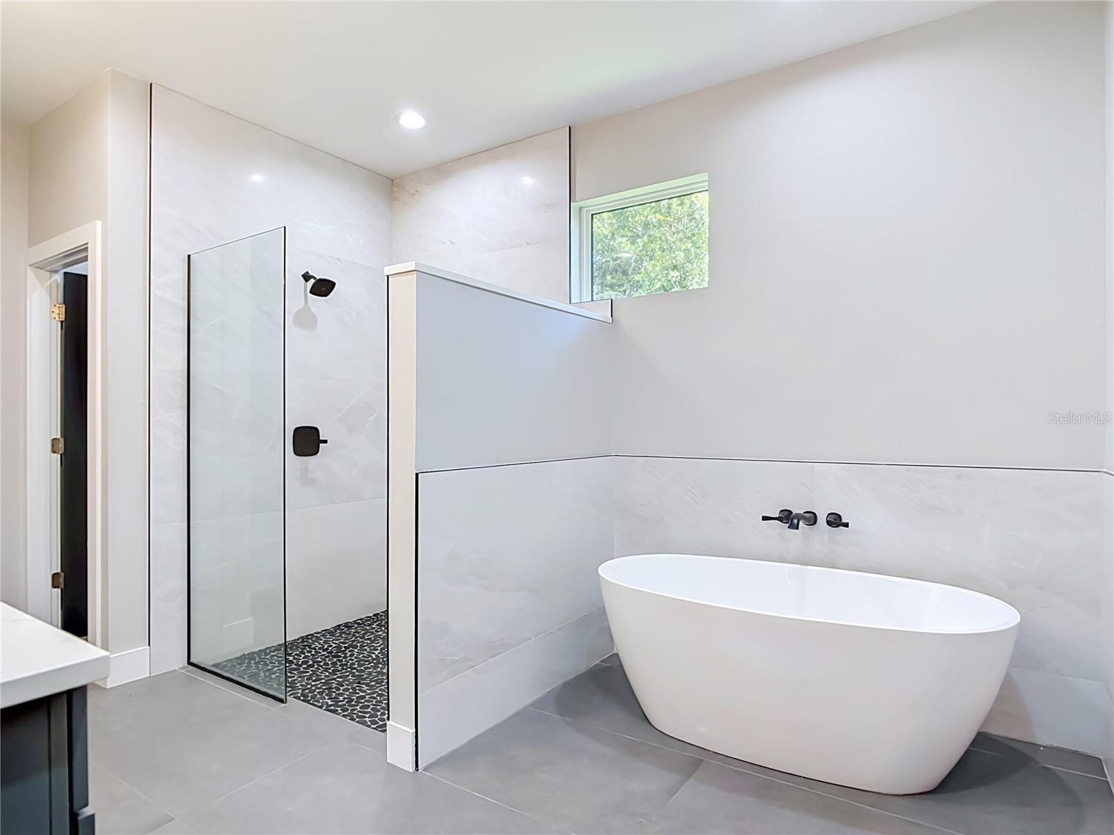 Primary Bathroom with separate garden tub and walk in shower