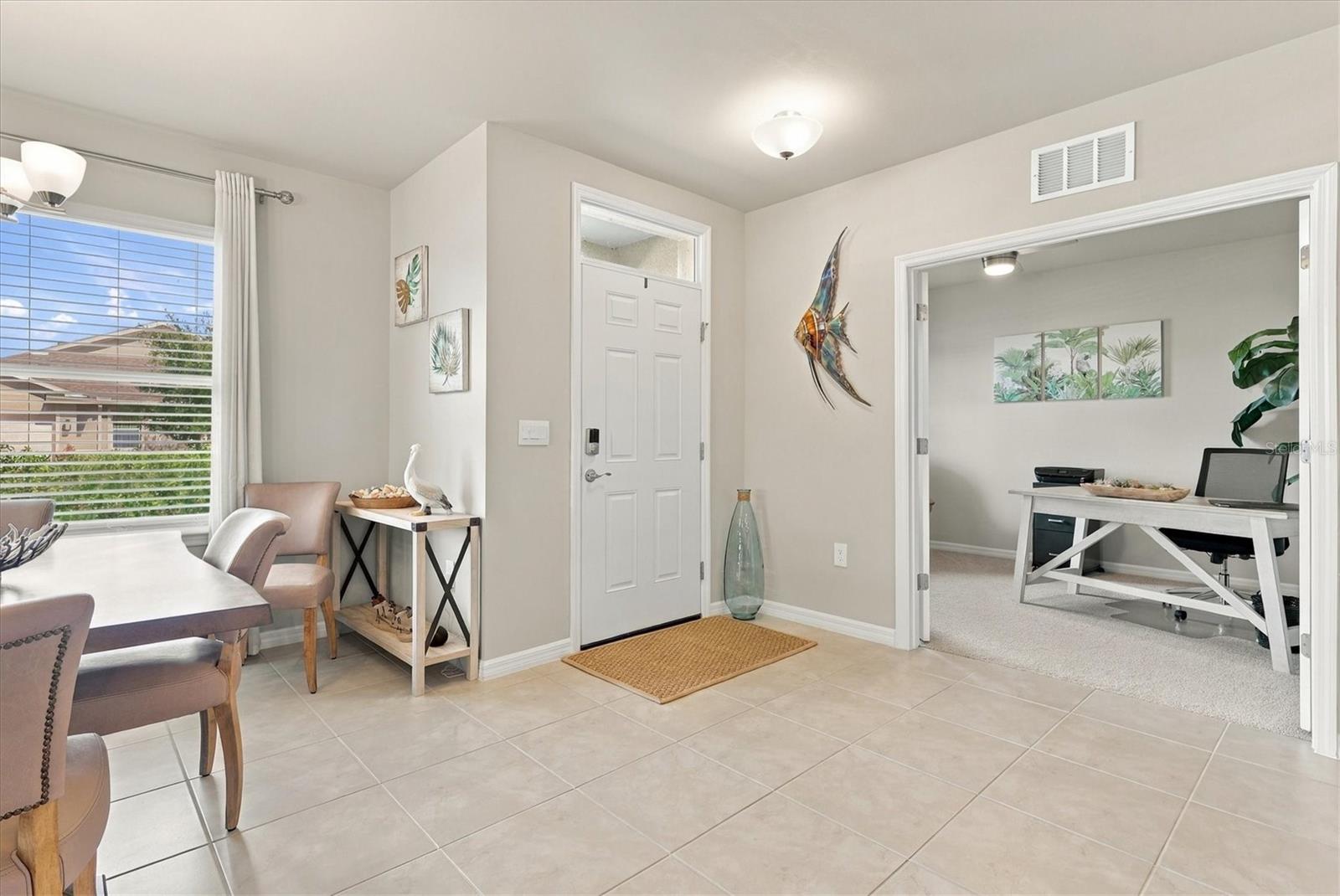 Entry Door with Den off to the left and Dining on the right