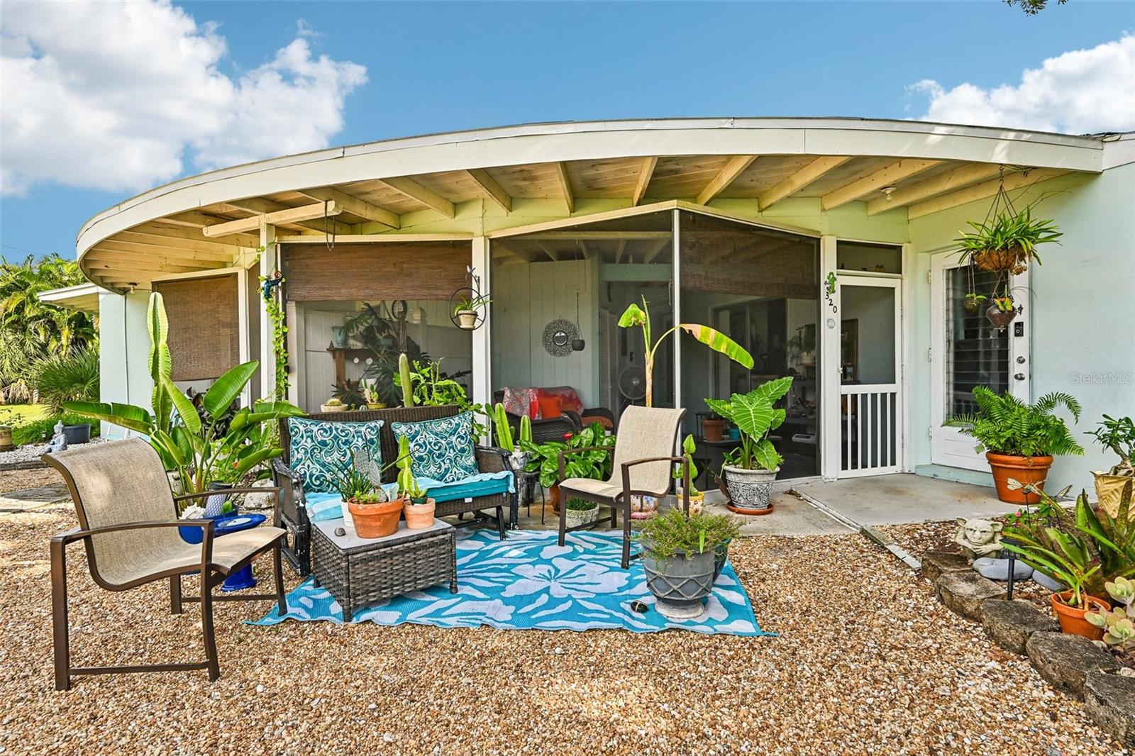320 - front door, screened lanai and outdoor seating / garden area