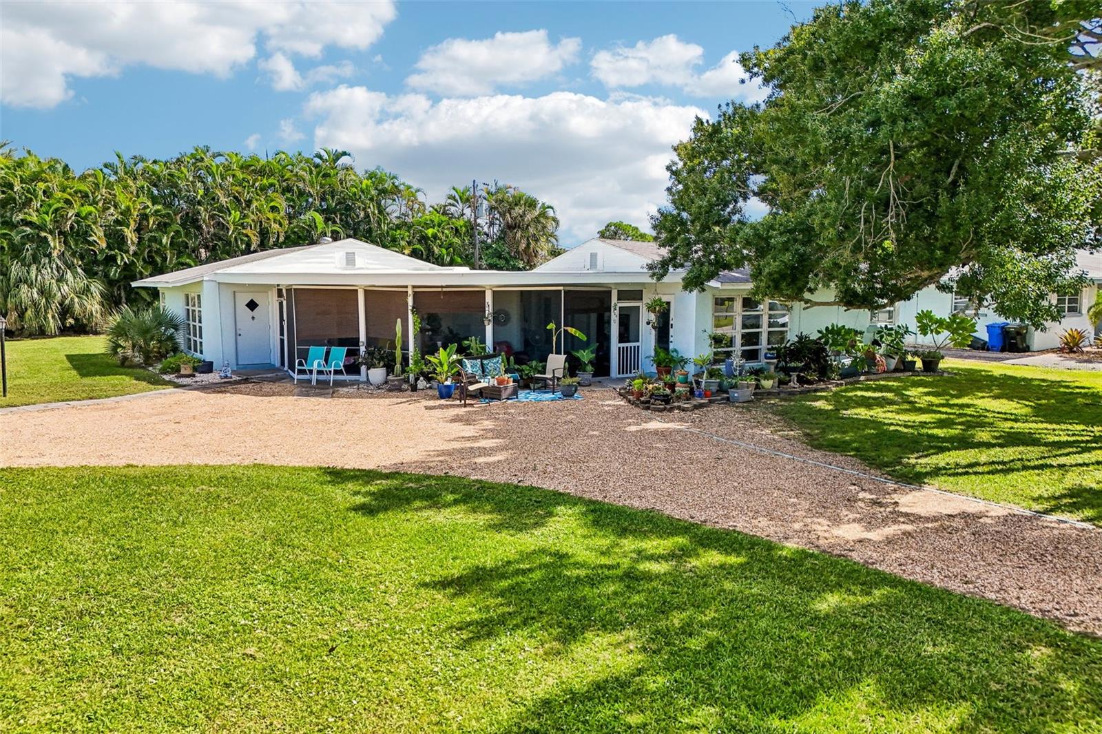 Front of house from street - 322 on left, 320 on right, screened lanais in center.