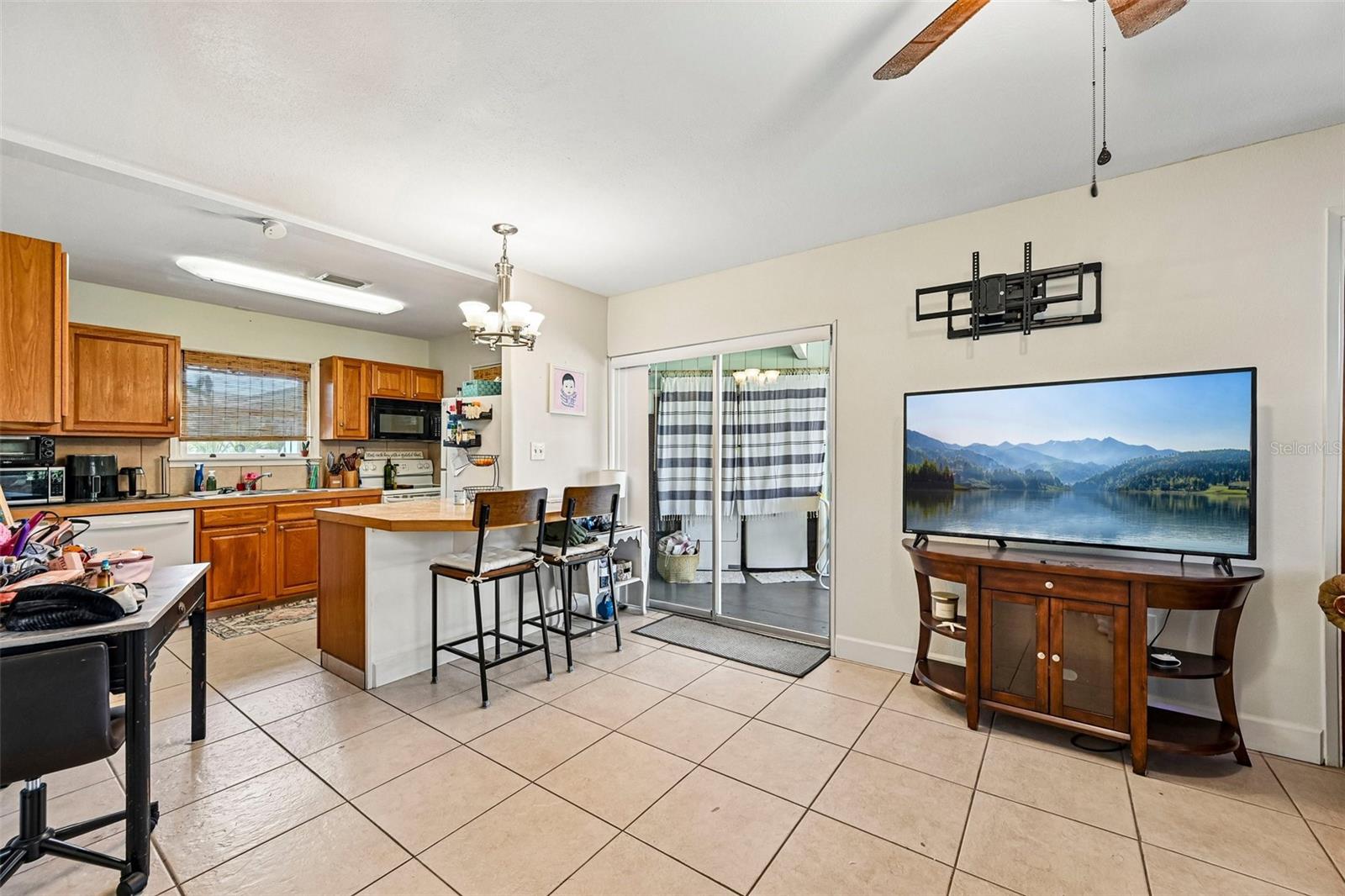 322 - glass sliders to lanai and laundry; open plan living room / kitchen / casual dining