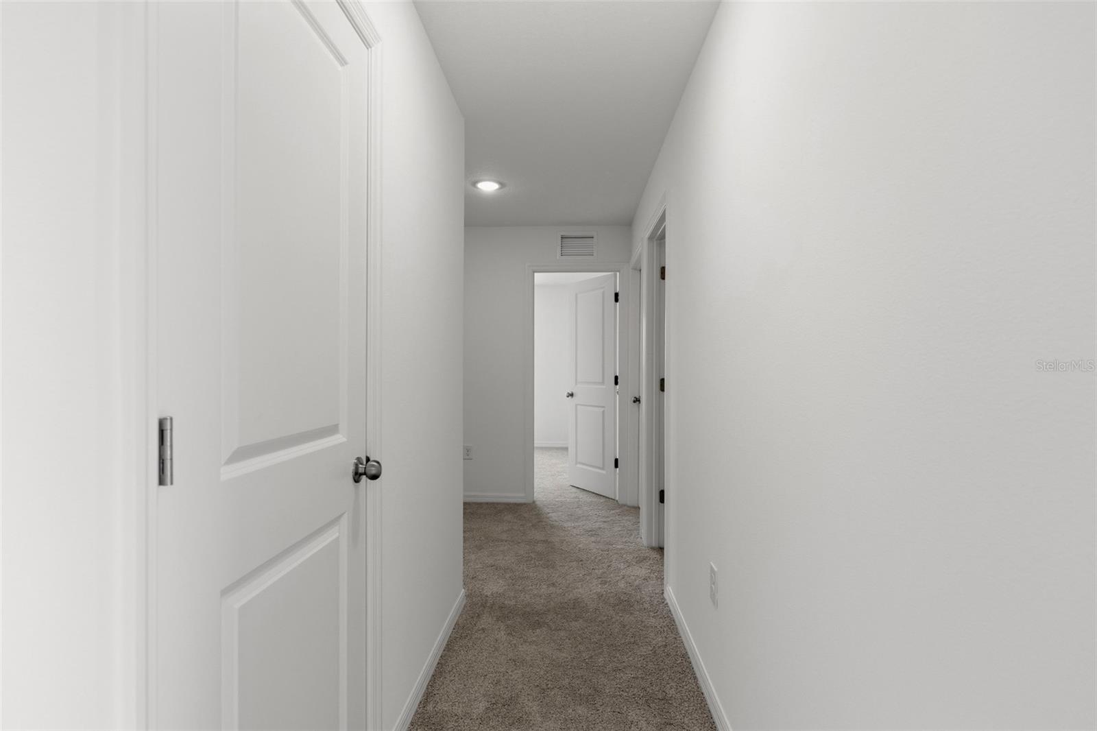Hallway to guest bedrooms and laundry room
