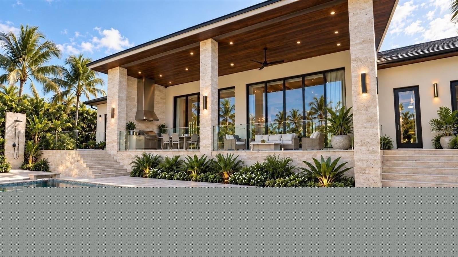 Patio with full outdoor kitchen, heated saltwater pool and hot tub spa. Virtually staged.