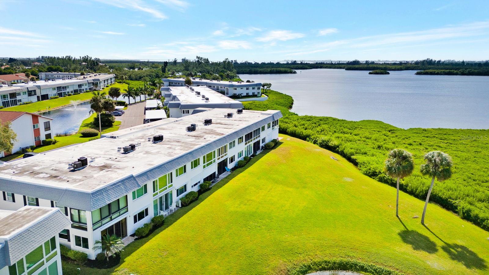 Aerial view of condo and water