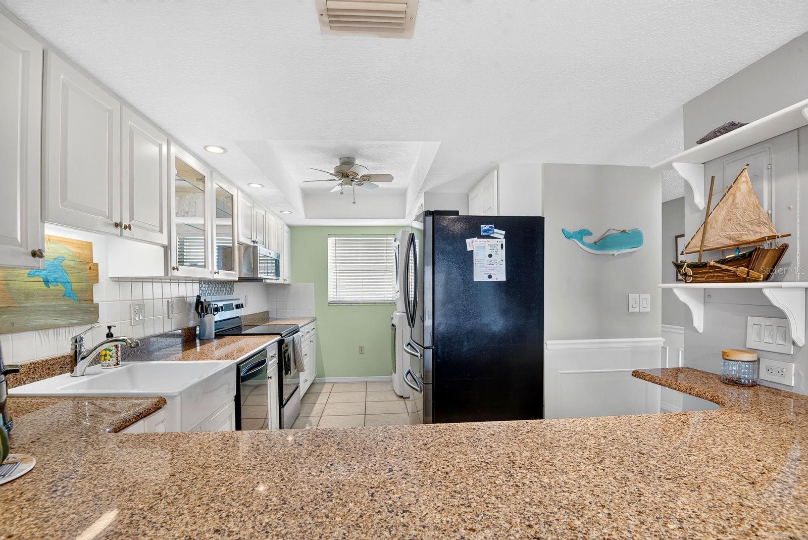 Facing into kitchen from dining area Facing into kitchen from dining area