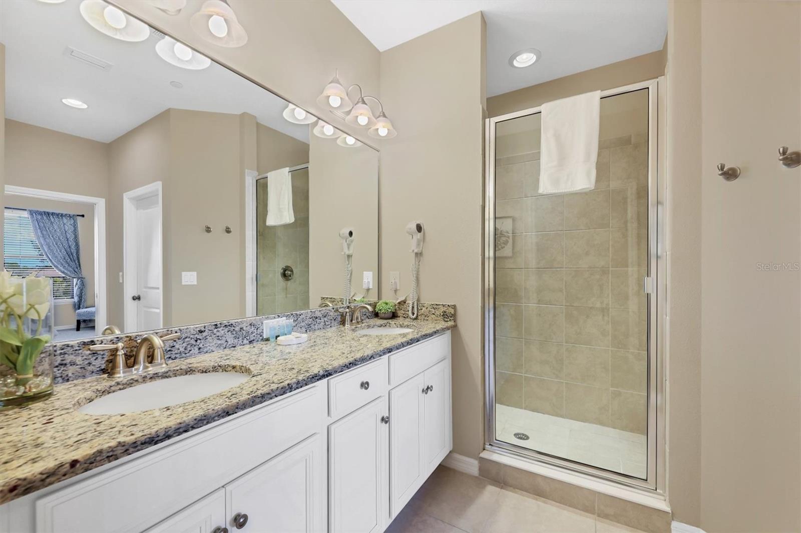 Dual sinks granite counters and large walk in shower