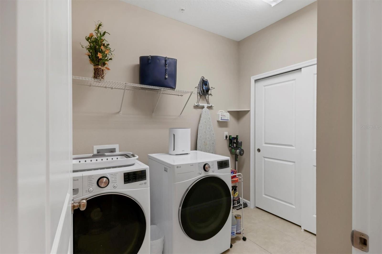 Laundry room with HVAC and water heater coset