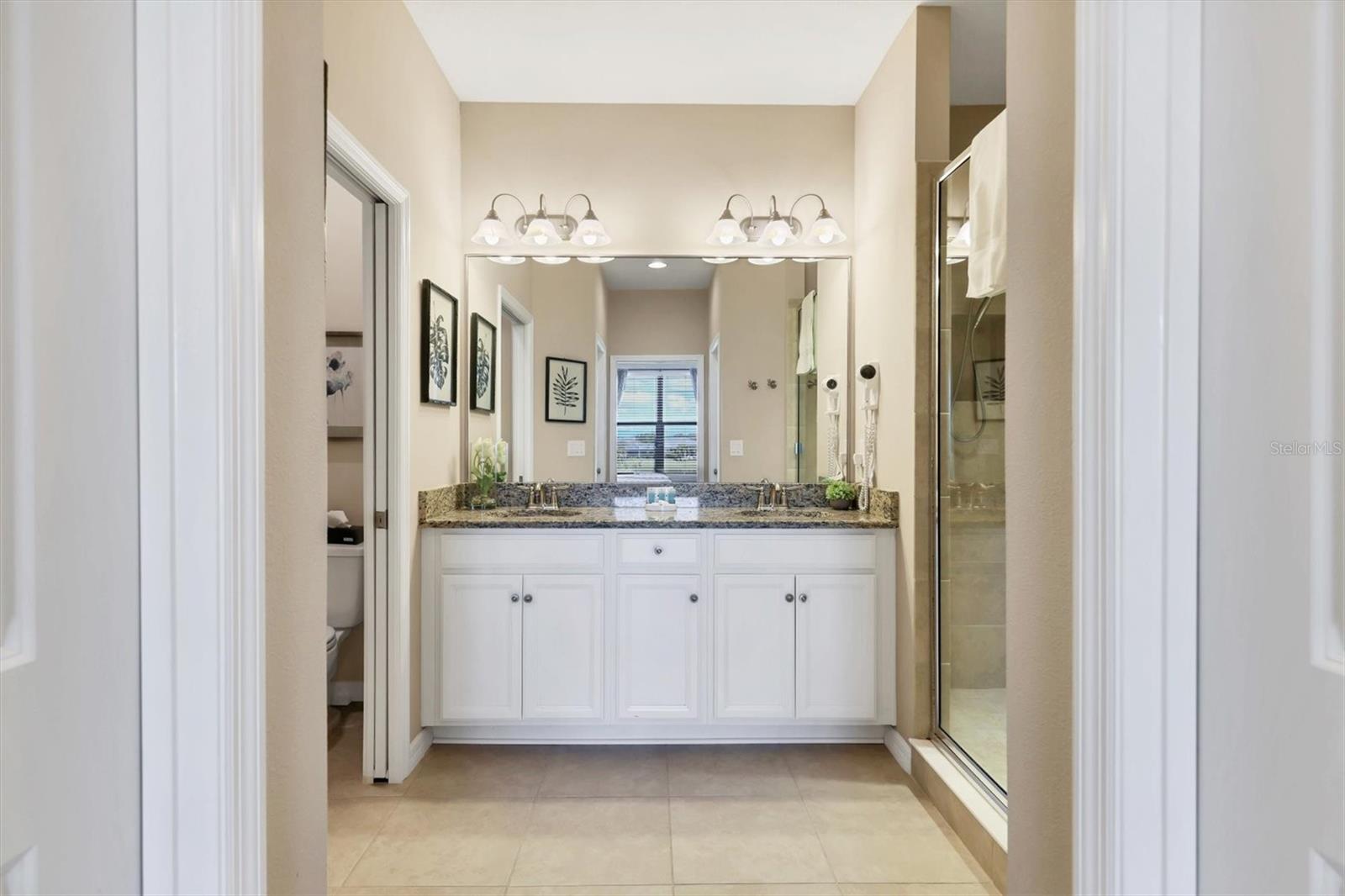 Primary bathroom with dual sinks and largeshower