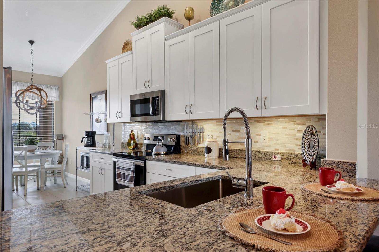 Granite Counters and tall wooden cabinetry