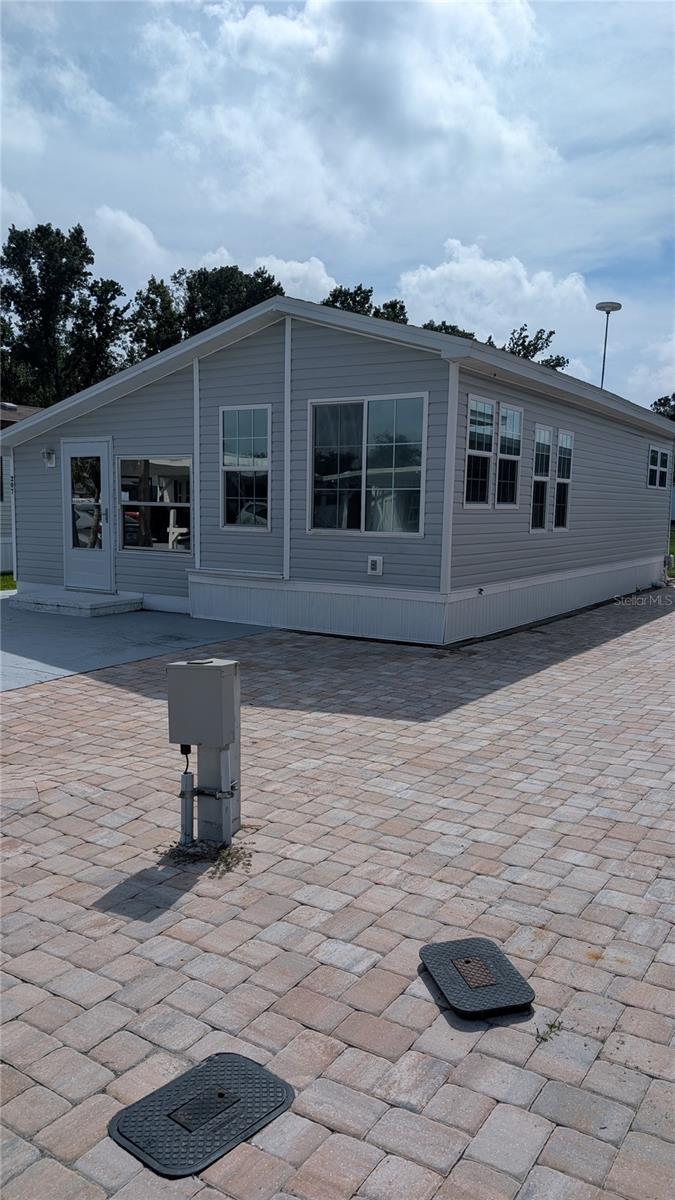 EAST SIDE VIEW. NOTE PAVED AREA