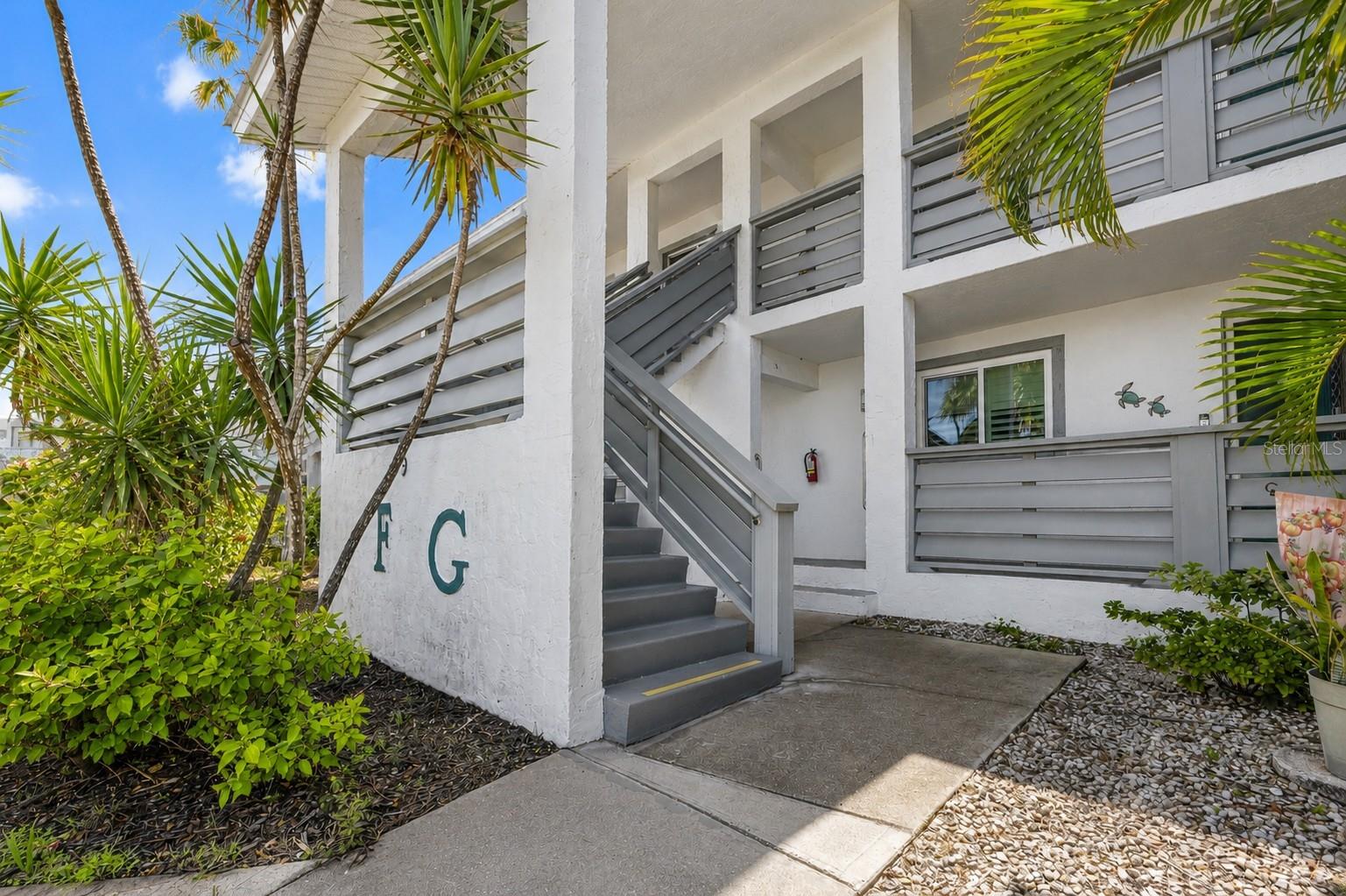 Welcome to Fiddlers Green. Follow the stairs to your next Florida home - Unit 235.