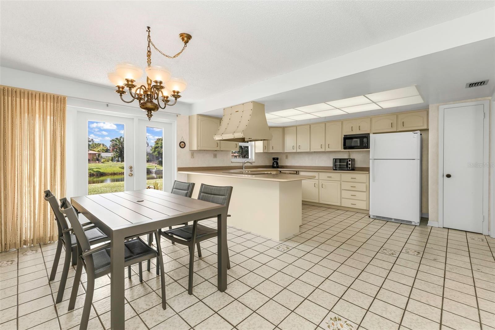 Functional kitchen with countertop breakfast bar and plenty of space for bar stools seating.