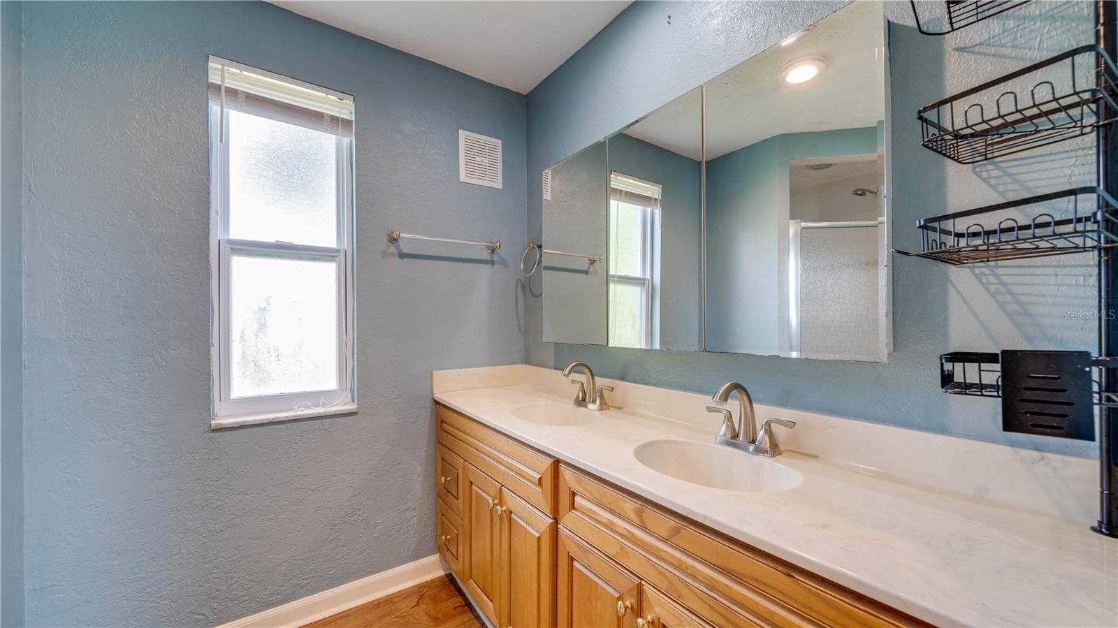 Primary Bath offers dual sinks, a walk-in shower, and brushed nickel fixtures.