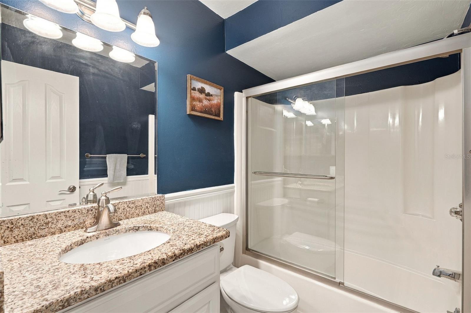 Guest Bathroom Features Granite Countertops and Tub/Shower Combo