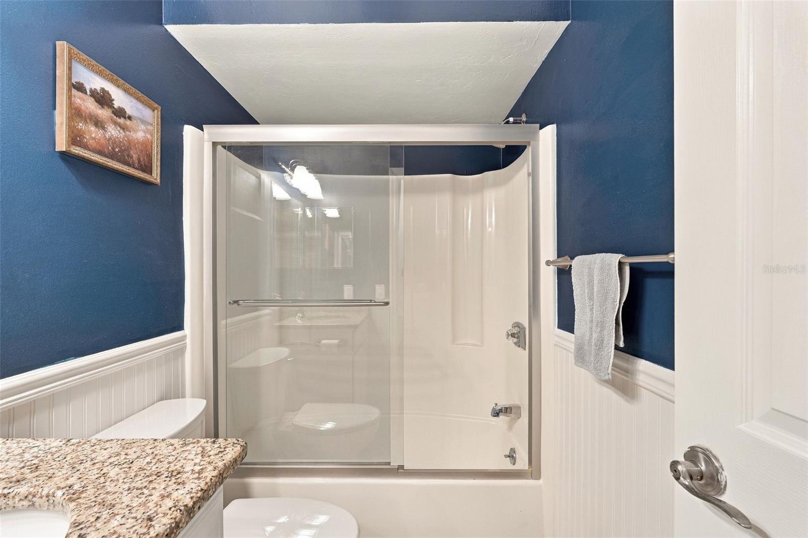 Guest Bathroom Features Granite Countertops and Tub/Shower Combo