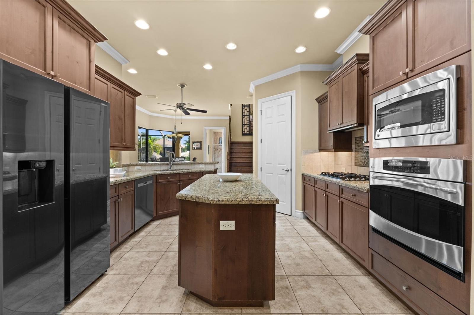 Lots of custom cabinets looking from the kitchen toward the pool area