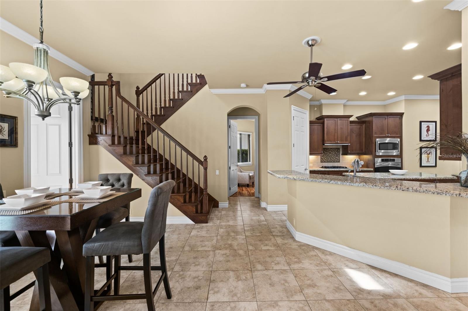 Looking toward the kitchen, breakfast area, and the stairway to the upstairs media room and bedroom 3
