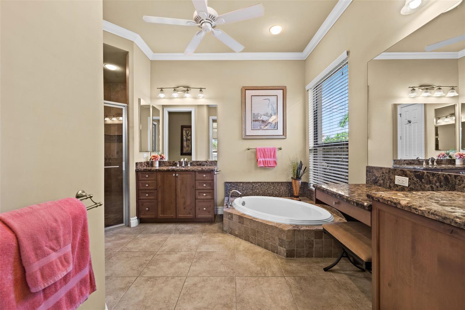 Primary bath has 2 separate sinks and a makeup vanity