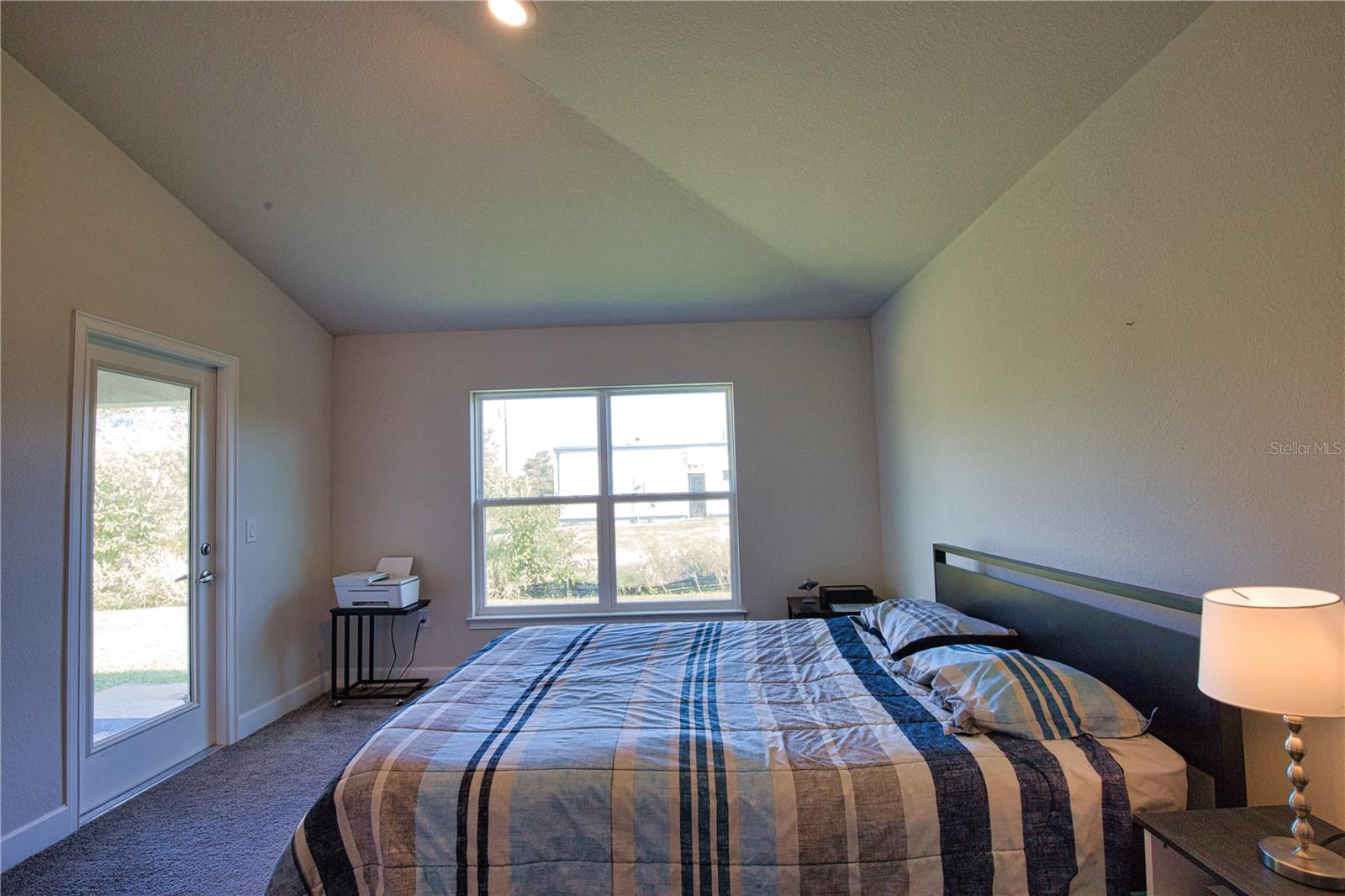 Primary bedroom with door out to the covered lanai