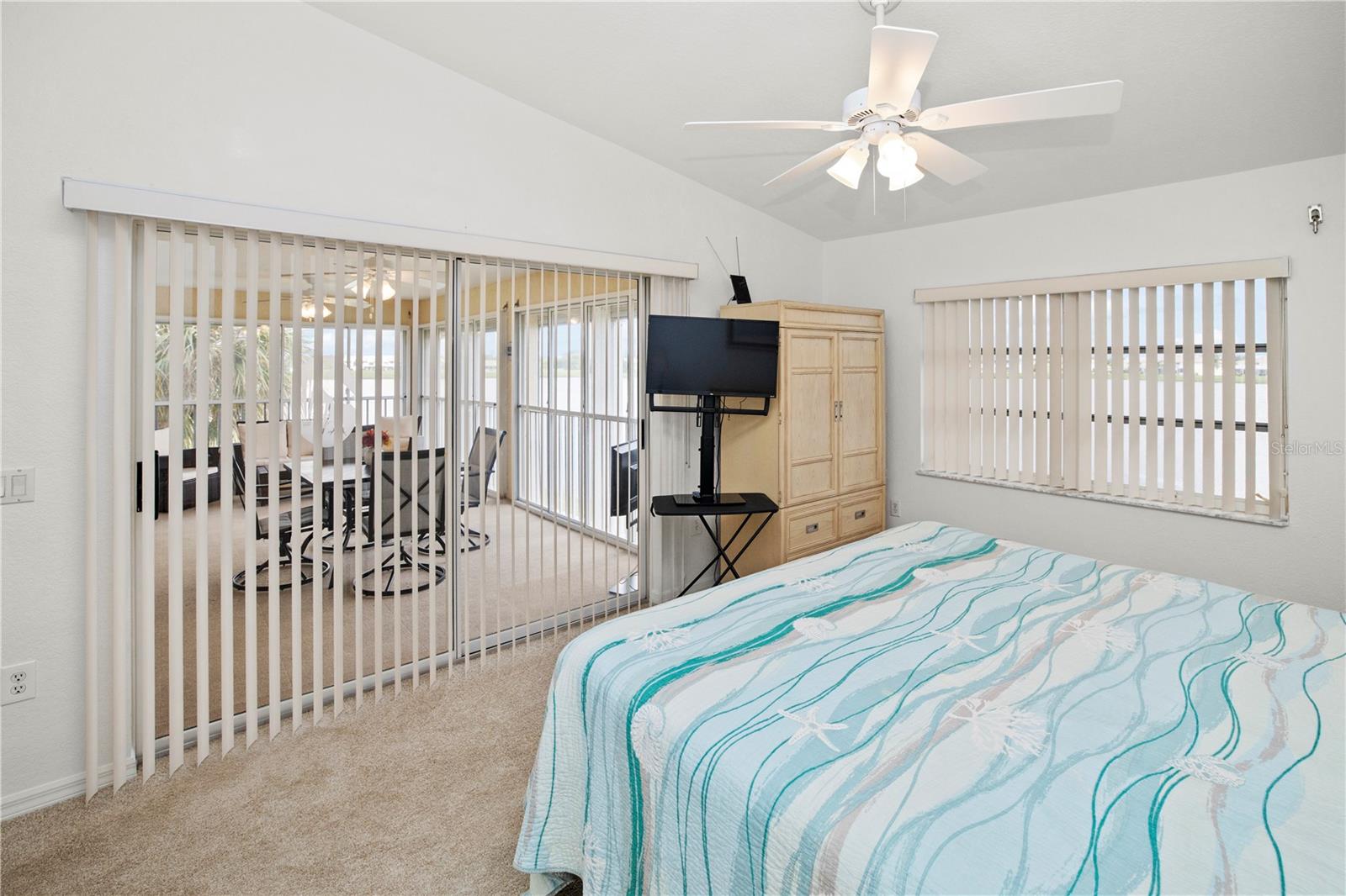 Spacious 12' x 16' Primary Bedroom with Gorgeous Lake Views and Sliders out to the Relaxing Lanai