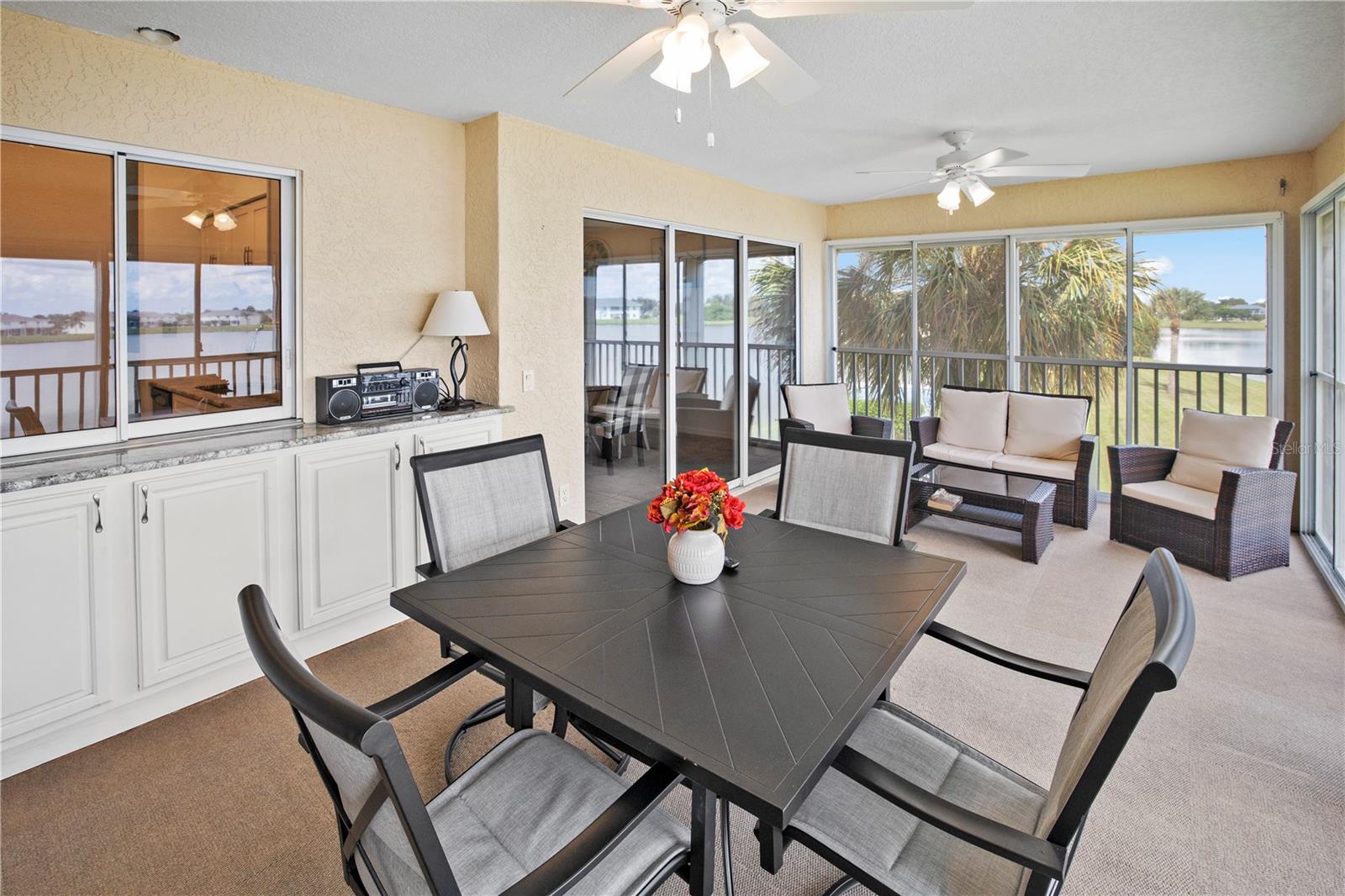 Impressive 20ft, 4 Season, Screened Lanai with Roll Down Shutters and Lake Rio View