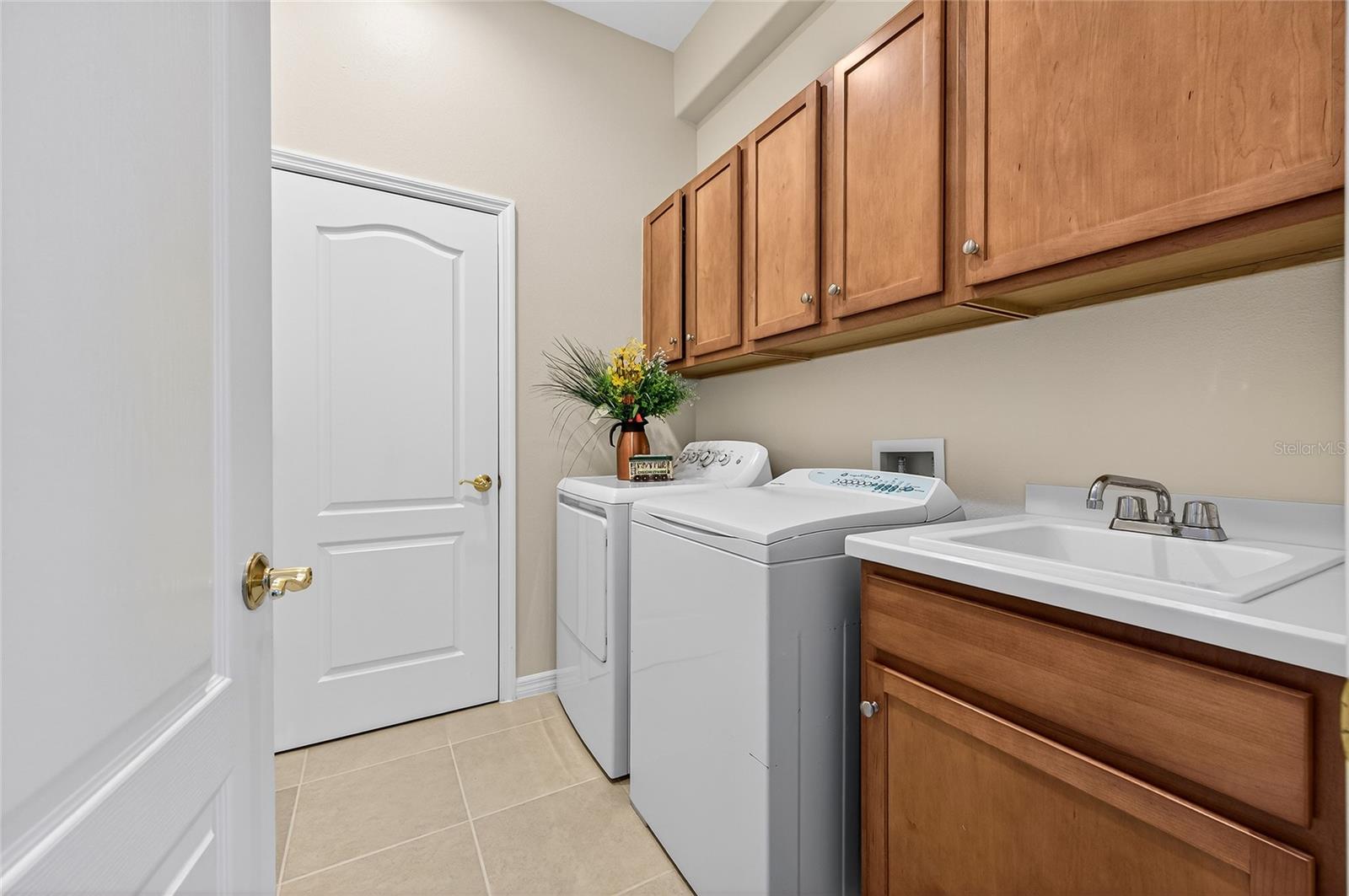 Laundry room with utility tub and closet