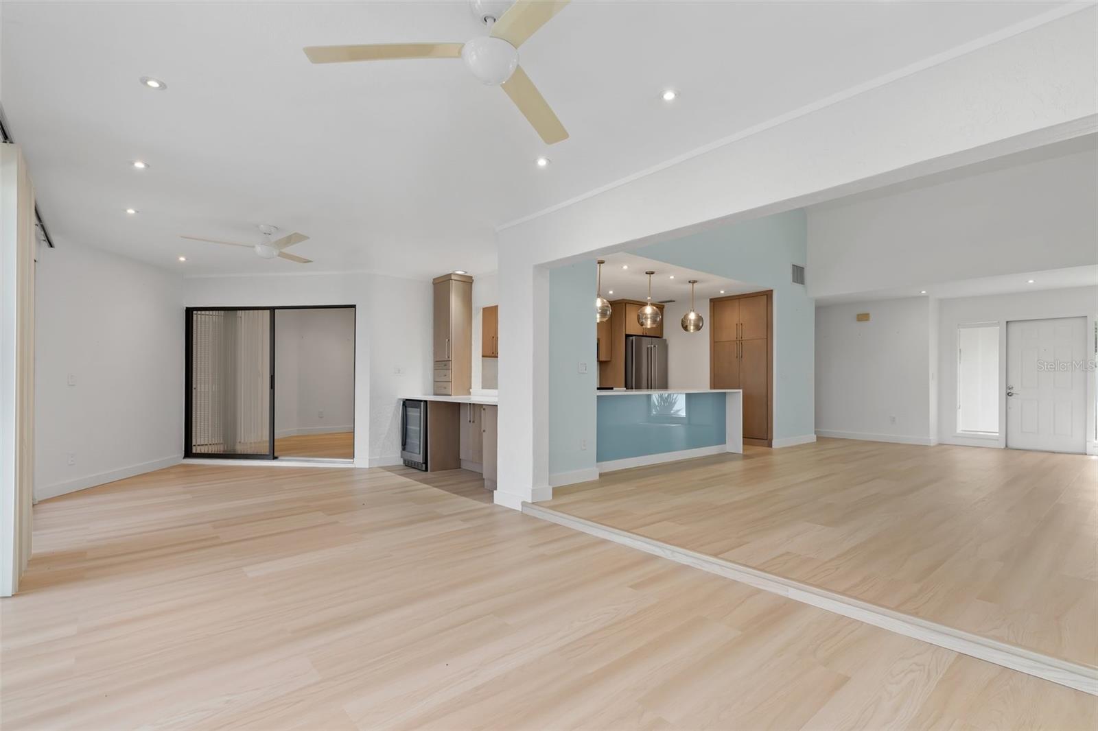 Standing at back sliders of family room and looking at open interior space. Dining, wine cooler, entertainment area.
