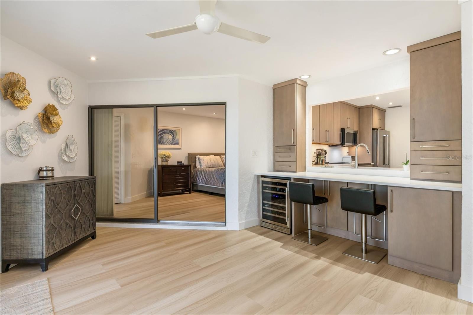 This area is designed for entertainment bar or office/computer area. Storage drawers on right have hidden electronic plugs and printer cabinet. On left end of bar is wine cooler and glassware cabinet.