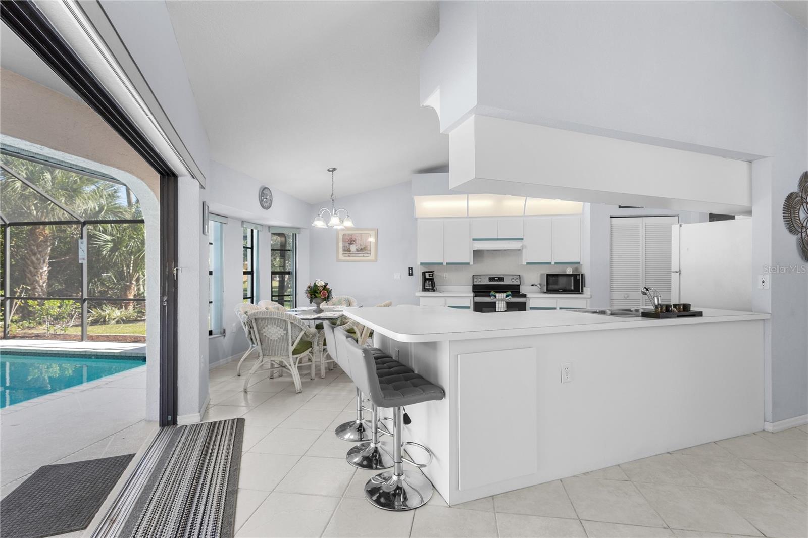 3 pocket sliding glass doors open from the Living Room and Kitchen.