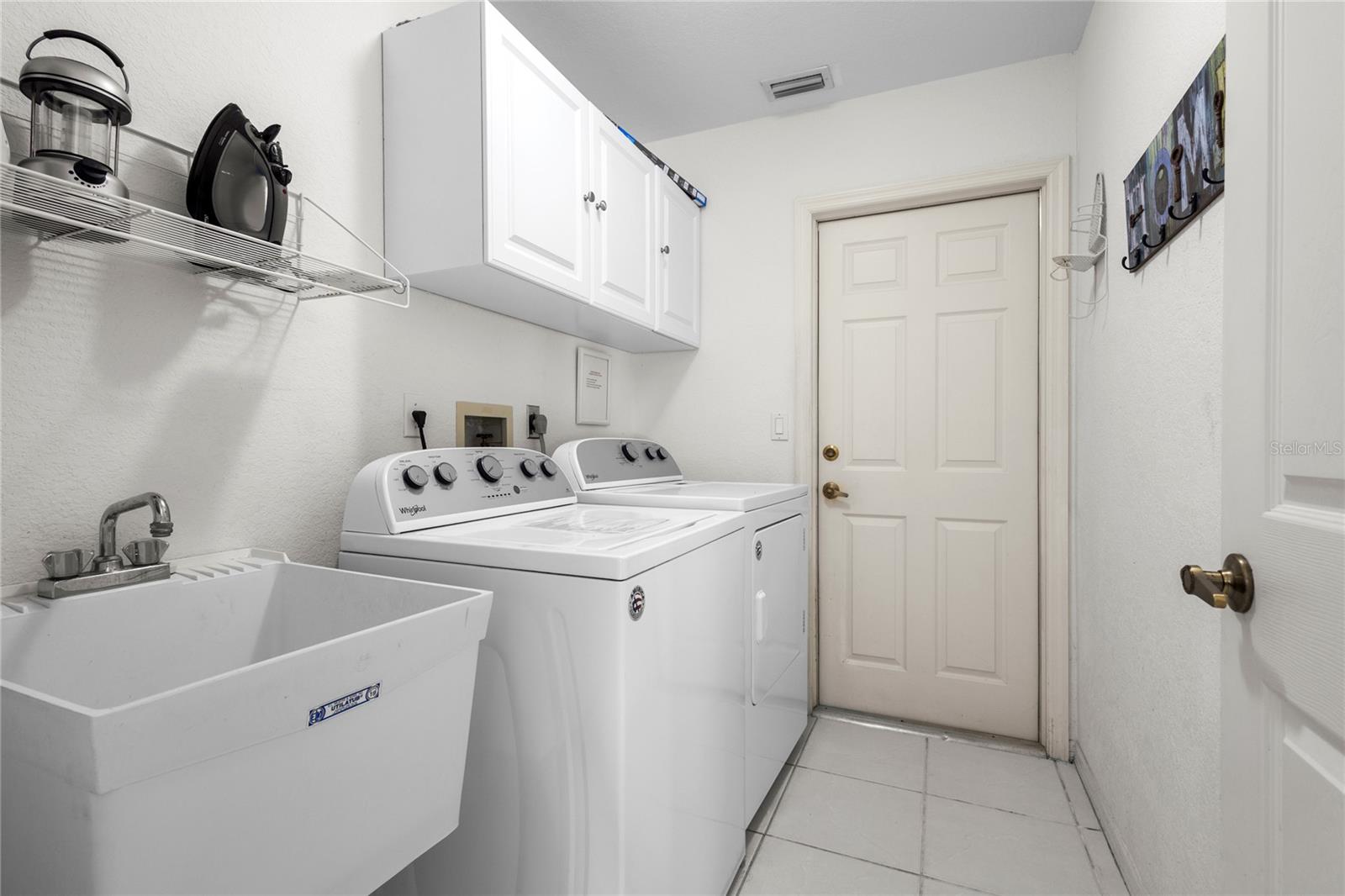 Laundry Room with laundry tub and cabinets.