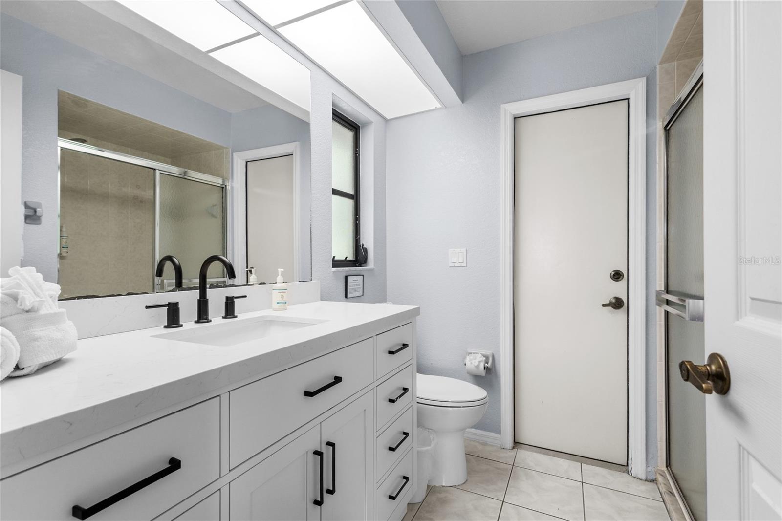 Primary Suite Bathroom with access to the Lanai and pool.