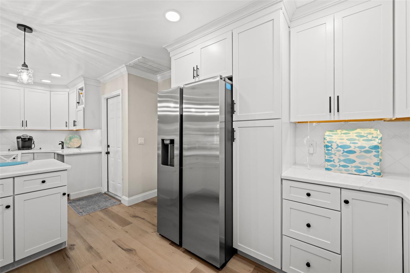 Just a few feet away, a built-in coffee bar and wet bar. More ceiling height cabinetry? Yes!