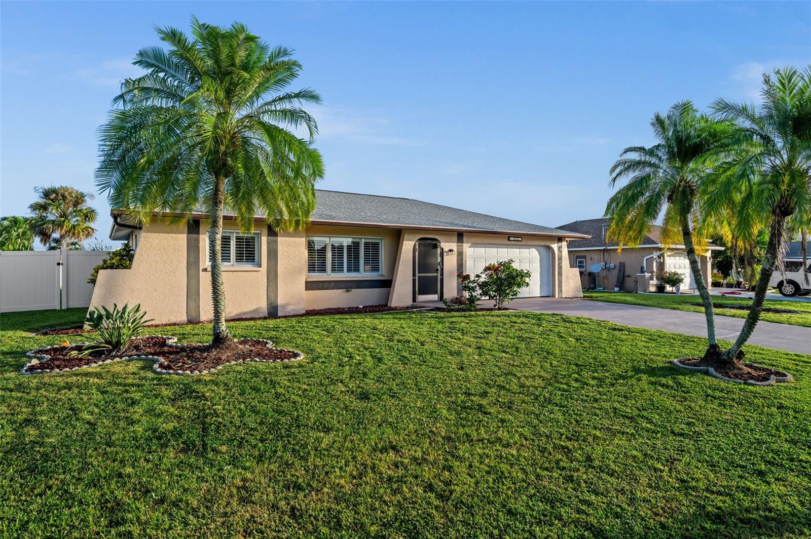 A well-loved home, mature landscaping, an attached 2-car garage...all on a quiet Cape Coral Street.