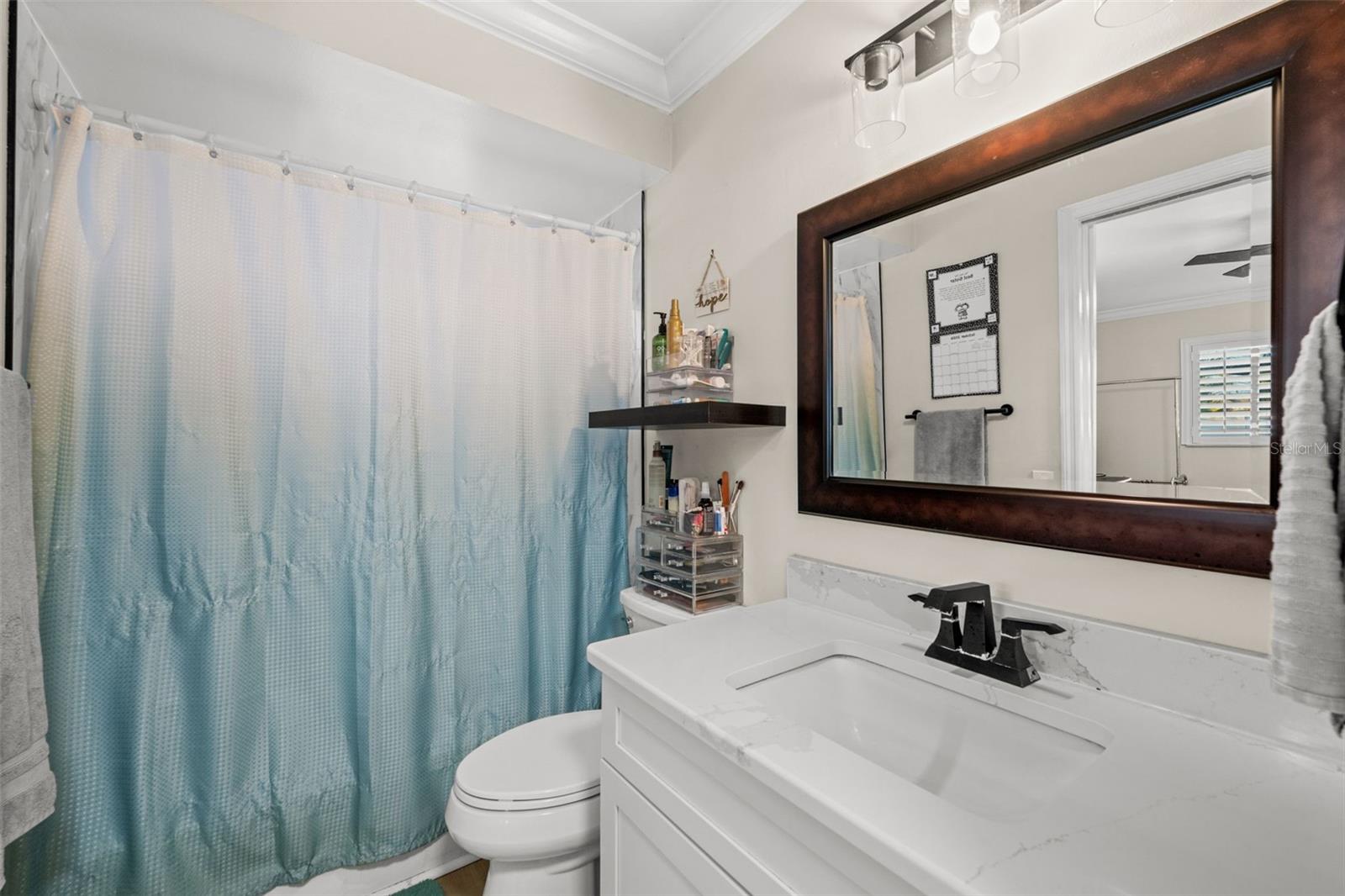 Quartz countertops and soft-close cabinetry in the primary ensuite.