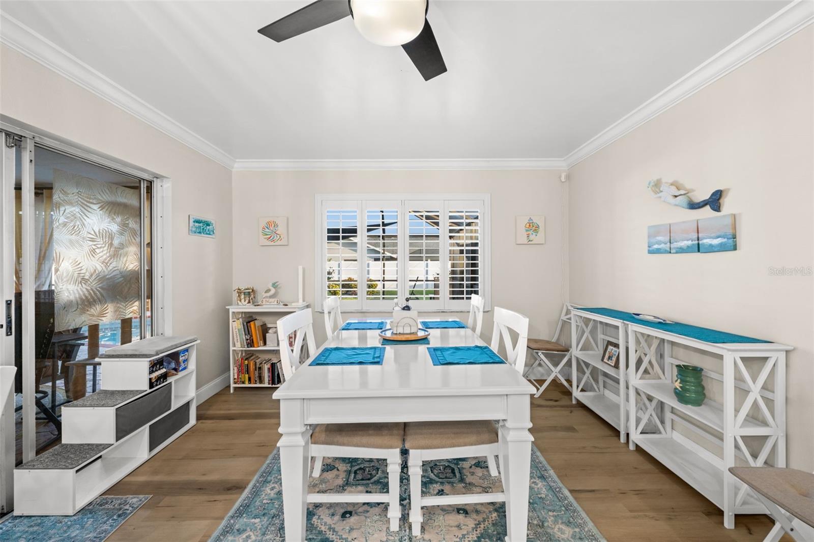A neutral palette, crown molding, and plantation shutters - all warm and inviting.