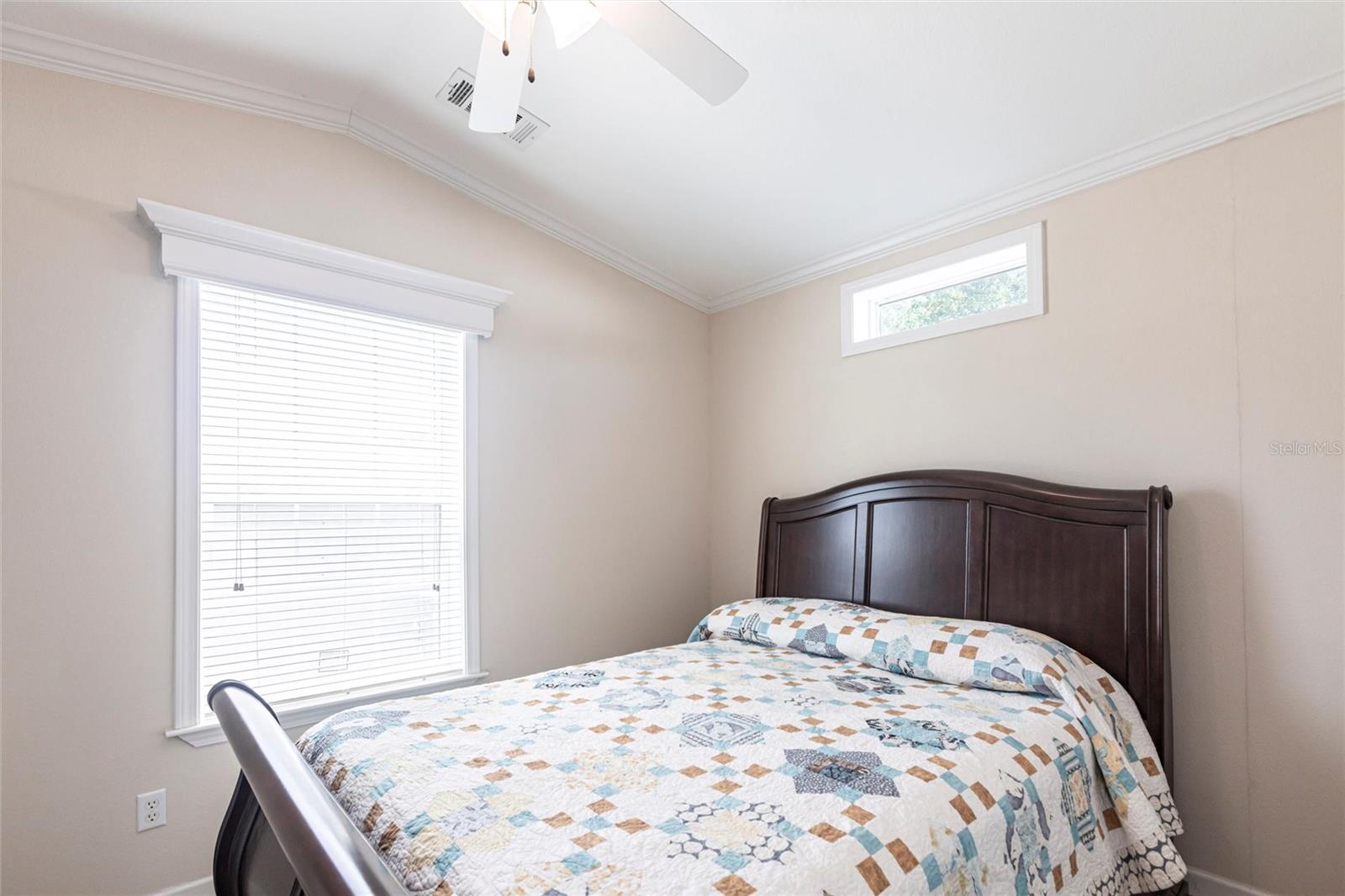 Bedroom with windows and ceiling fan