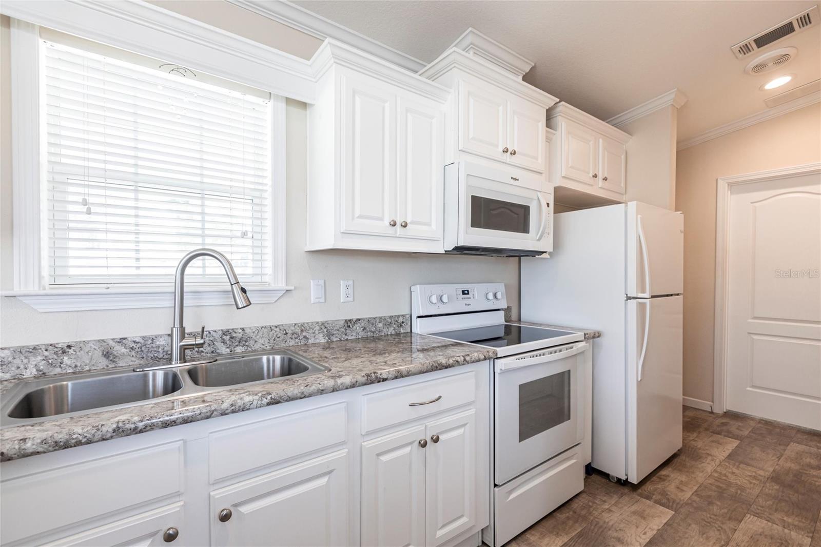 Kitchen with white cabinets and appliances