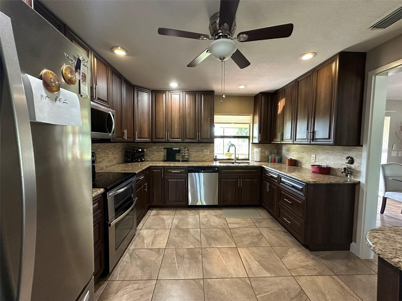 Custom kitchen with 42" wood cabinets, granite counters and tile backsplash.