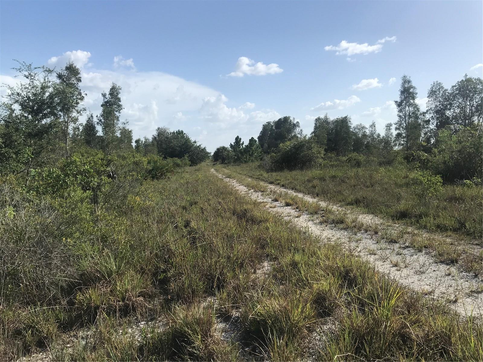 Drive ahead to rear of the 70 acres and the Lake.