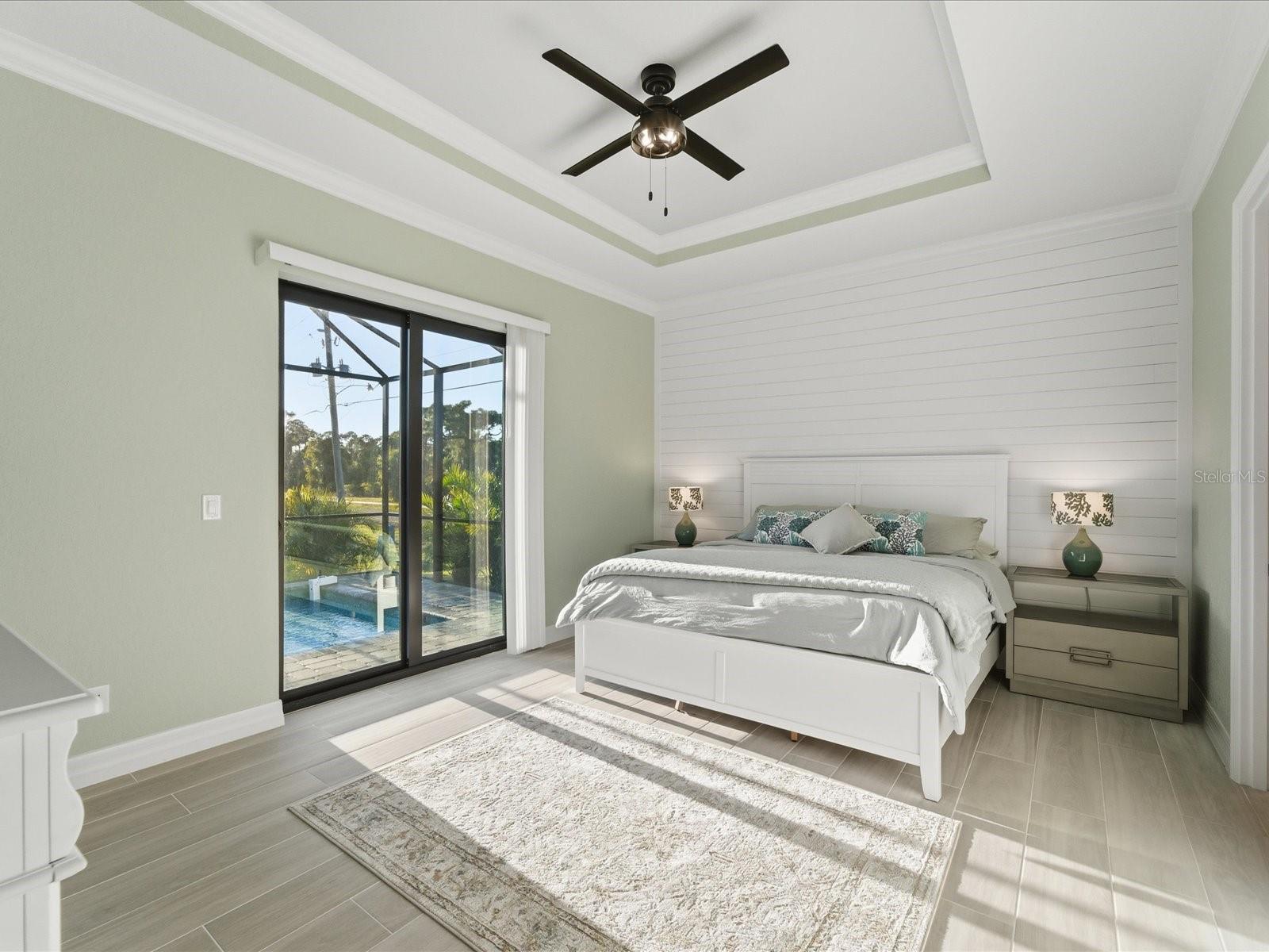 Primary Bedroom with access and view of the pool