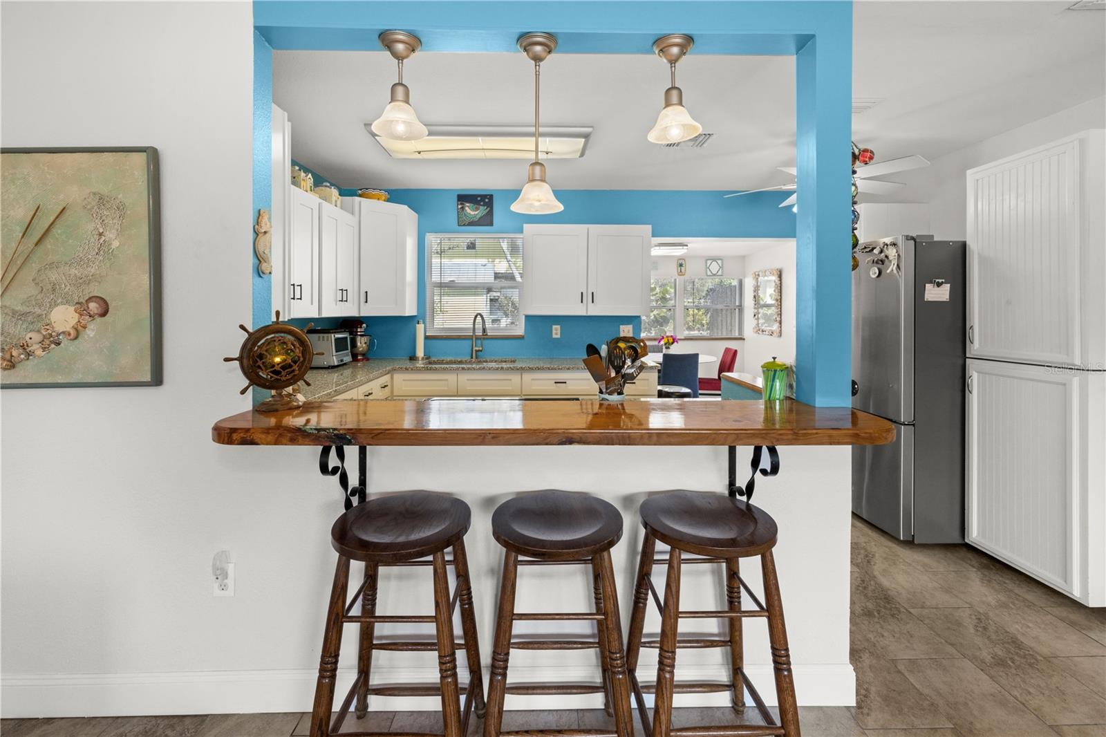 The pass through counter connects the living room to the kitchen and the dining area.  It's a great open concept that allows conversations while you cook!