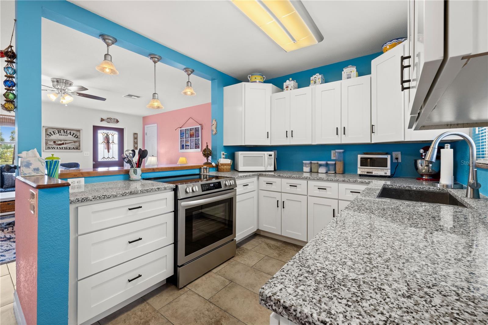 Here's another view of the kitchen.  The kitchen sink is deep and there is an exterior view through the window above it.