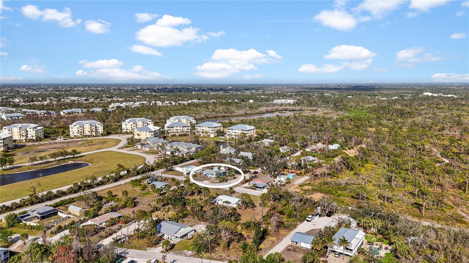 The large buildings to the north are The Hammocks, and the forested area to the south is portion of the 225 acre Amberjack Environmental Preserve.  At the end of the road is a gate where you can enter the Preserve to hike the trails.