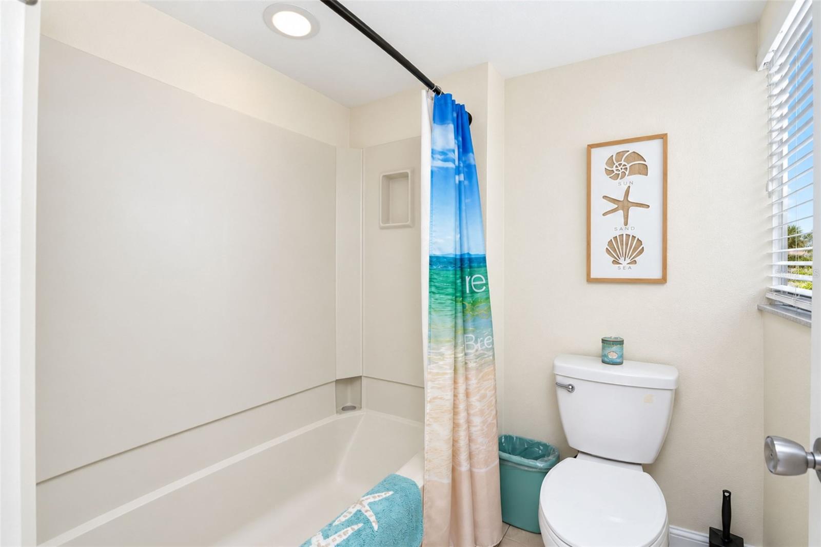 The guest bathroom has a tub/shower combo and a new toilet.