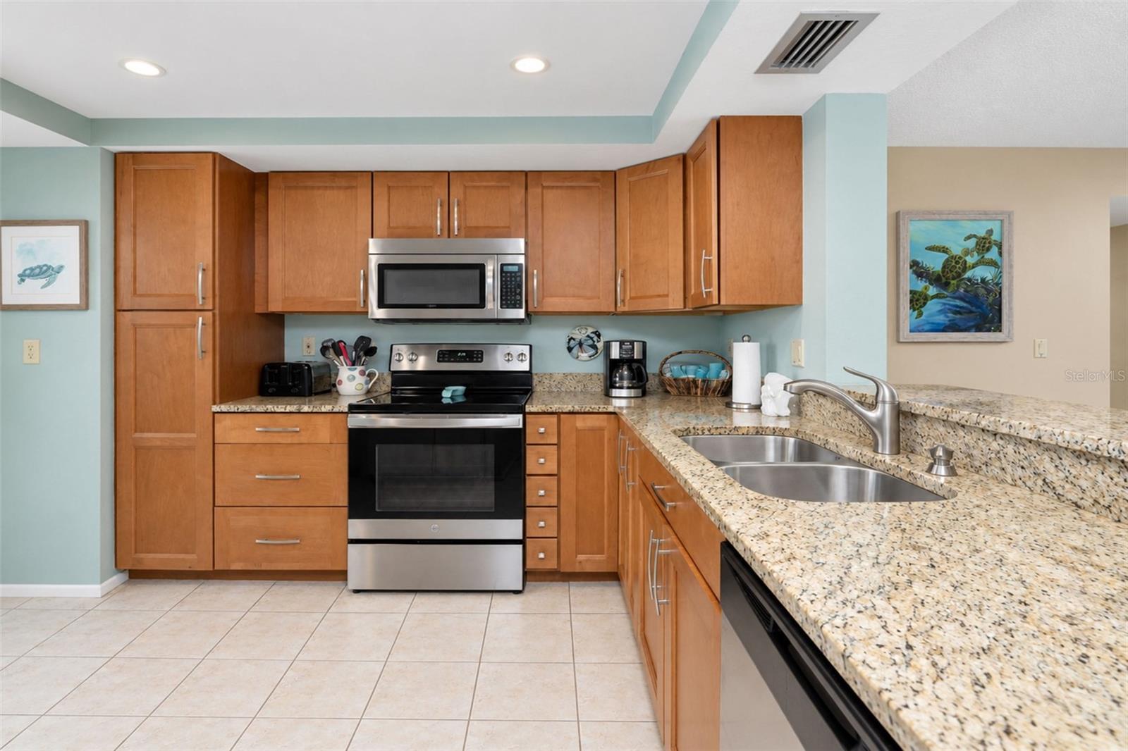 The kitchen features a GE stove, Frigidaire dishwasher and a Whirlpool microwave...all stainless steel!