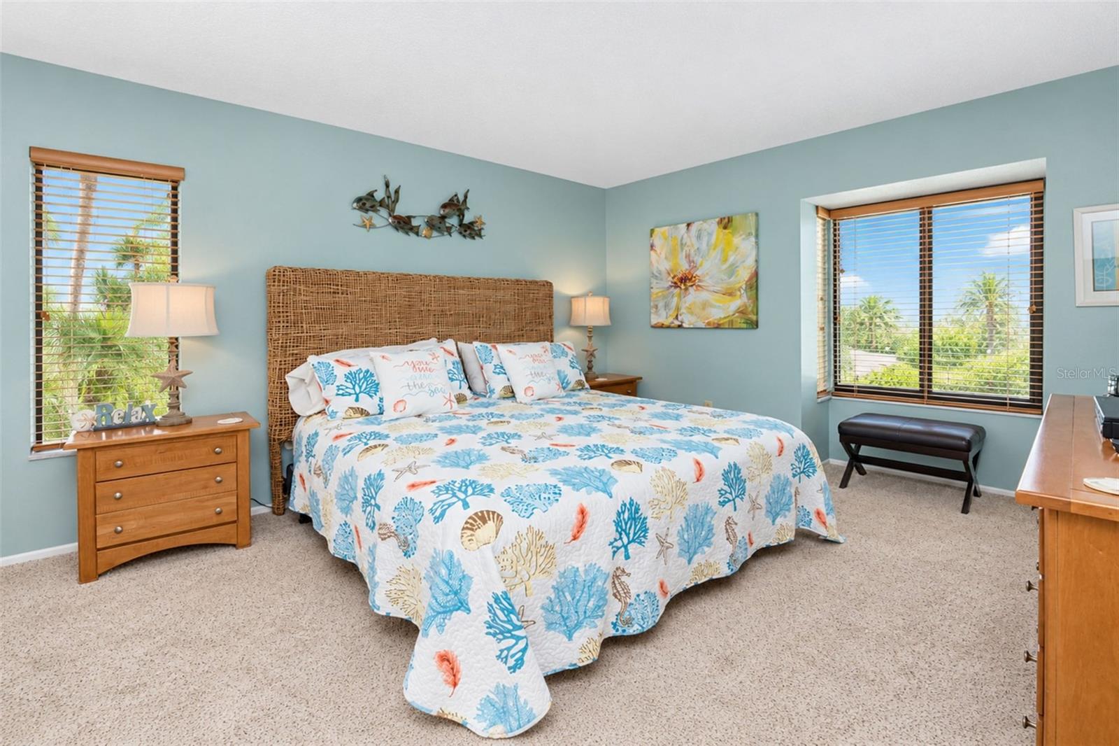 The primary bedroom features carpeted flooring and natural light.