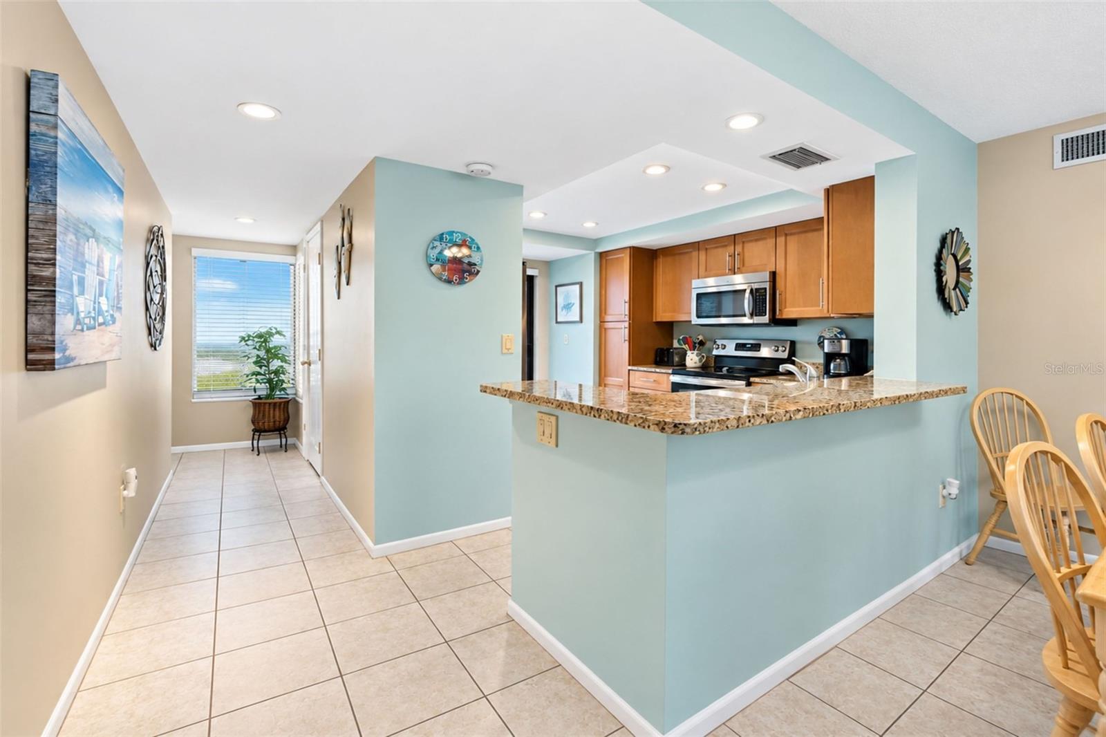 The kitchen features tiled flooring and a high top breakfast bar. The kitchen features tiled flooring and a high top breakfast bar.